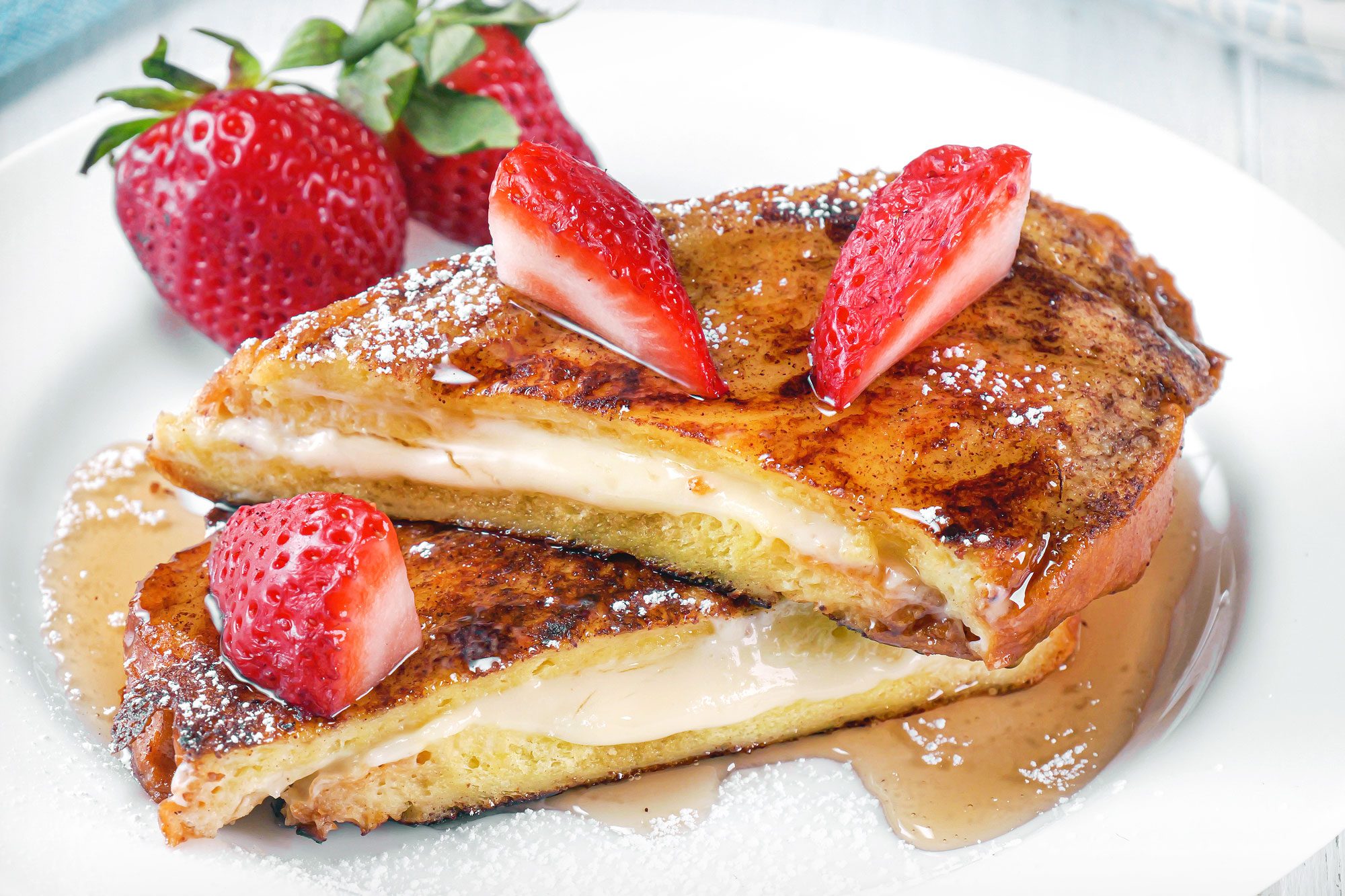 close shot of stuffed french toast topped with strawberries