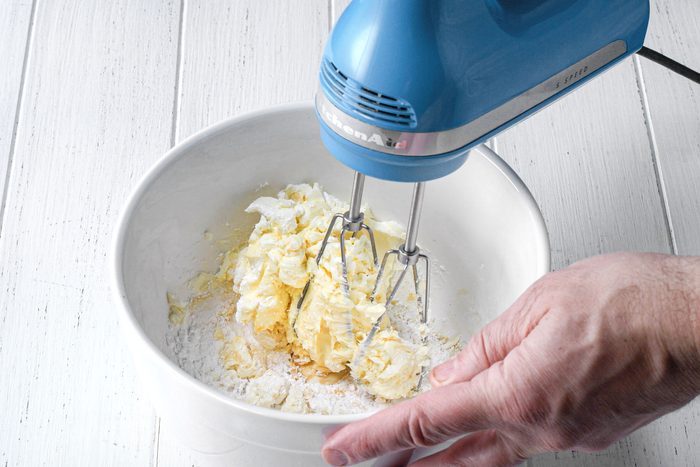wide shot of blended cream cheese and sugar in a bowl