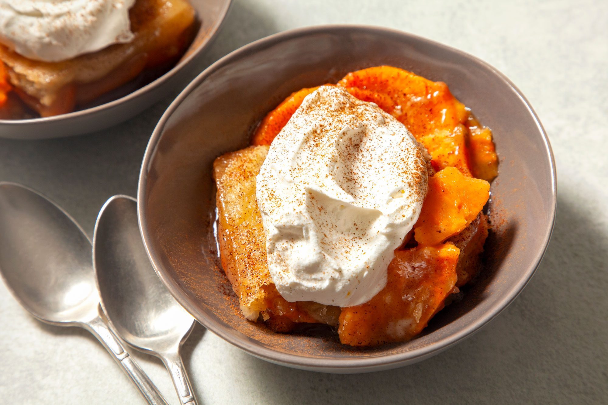 high angle shot of sweet potato cobbler topped with whipped cream