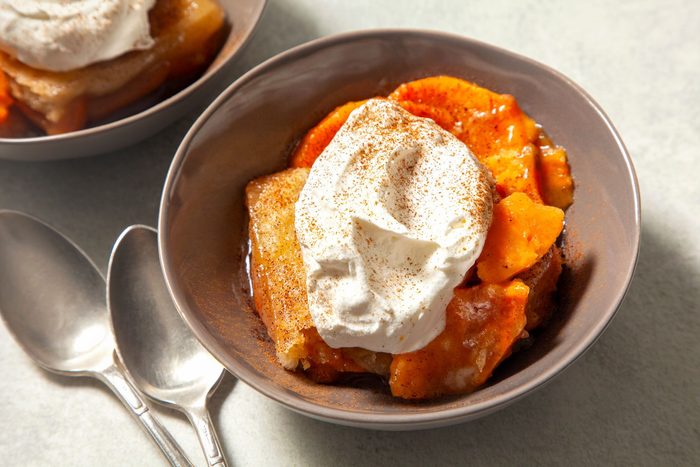 high angle shot of sweet potato cobbler topped with whipped cream