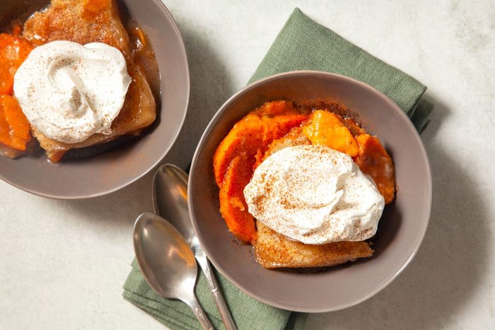high angle shot of sweet potato cobbler garnished topped with whipped cream