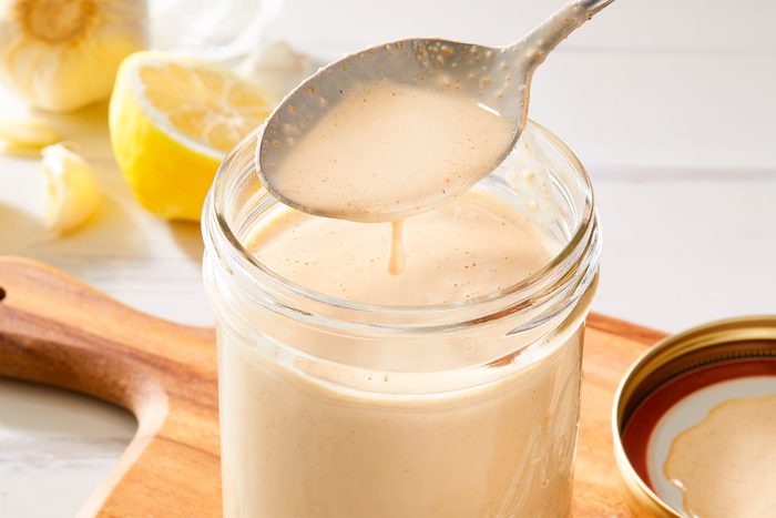 close shot of tahini dressing in a jar