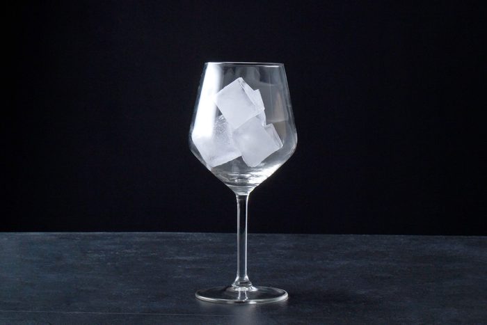 wide shot of large wine glass with ice cubes