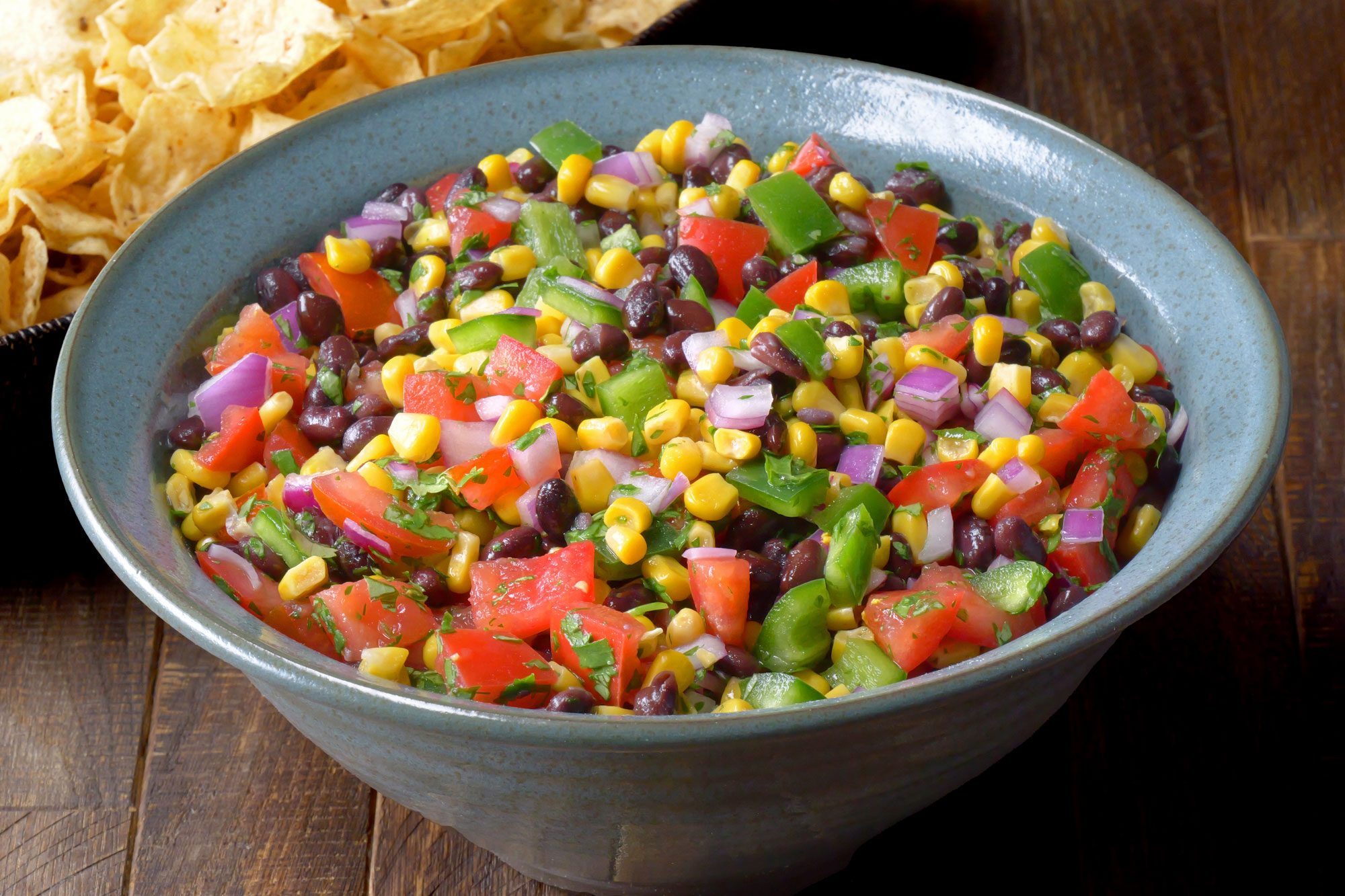 Black Bean And Corn Salsa served in a large bowl with tortilla chips