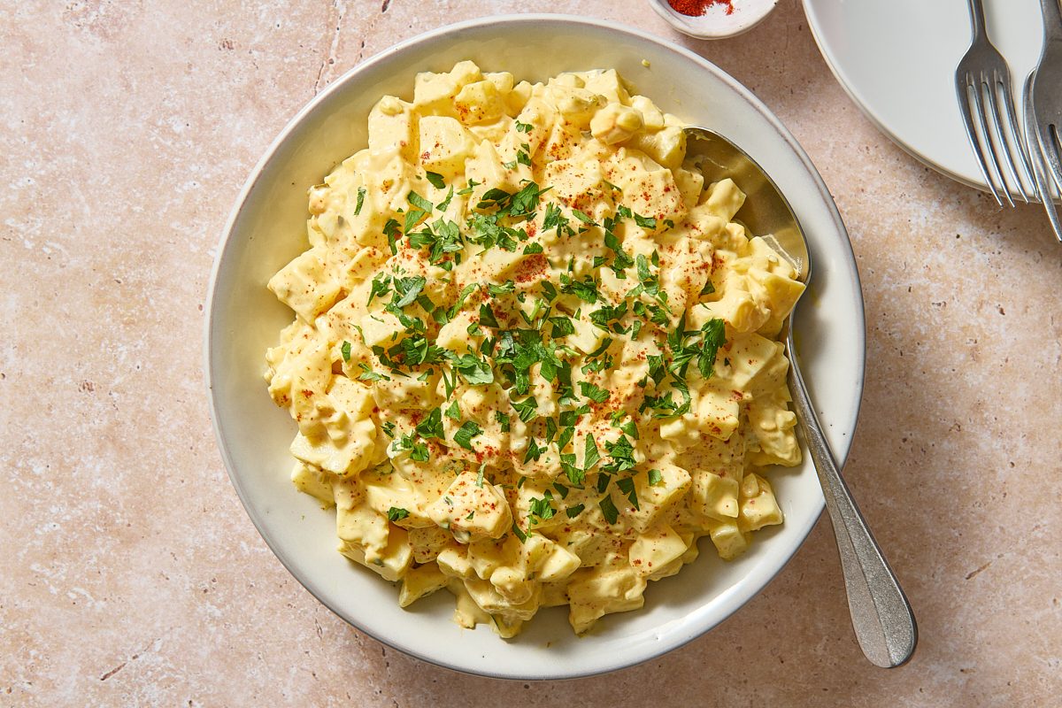 Overhead shot of Cajun potato salad in a large bowl with a spoon