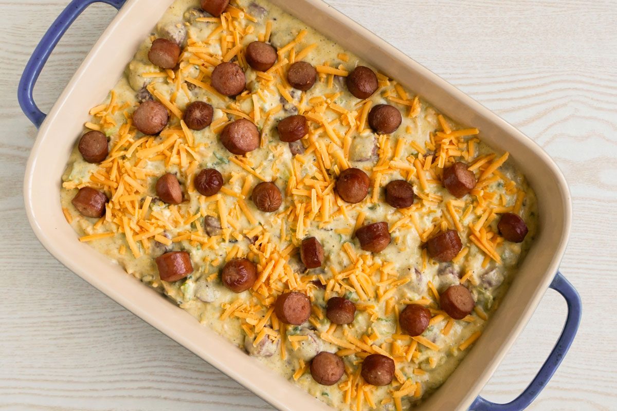 corn dog casserole in baking dish ready to be baked