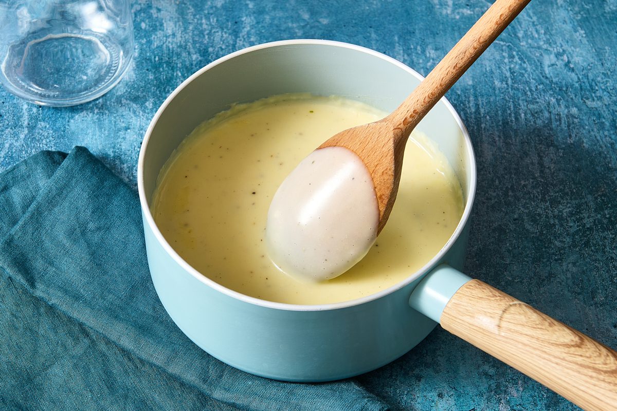 Cream of chicken soup in a saucepan and coating the back of a wooden spoon