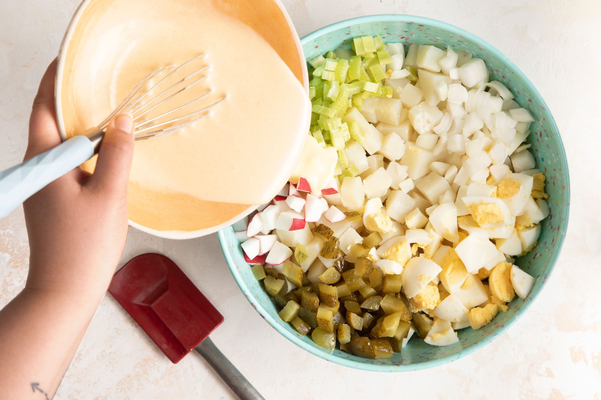 In a small bowl, whisk together the mayonnaise, sugar, vinegar, milk, mustard and salt and pour over potatoes mixture