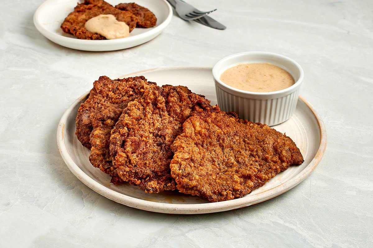 This crispy fried cube steak recipe by Taste of Home marries buttermilk and evaporated milk into its batter to yield and extra-flavorful and tender cutlet.