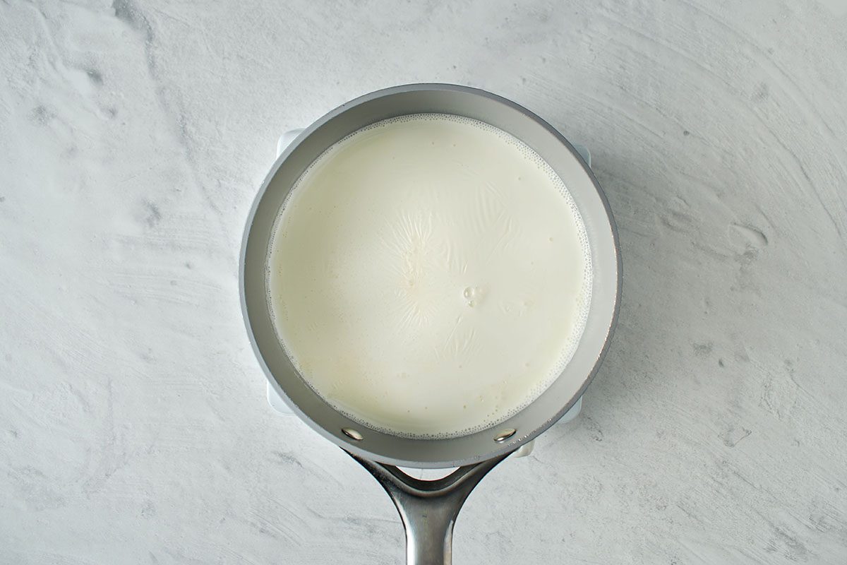 Heat milk and heavy cream.