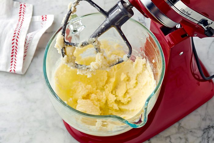 In a large bowl, mix cream butter and sugar until light.