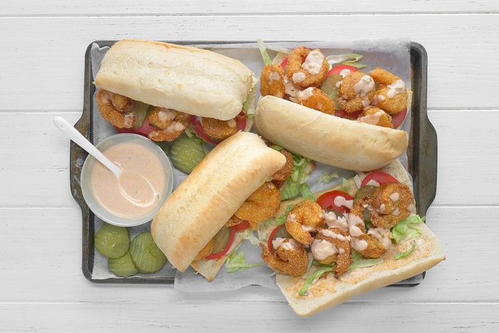 overhead shot; white background; Shrimp Po'Boys served on rectangular tray