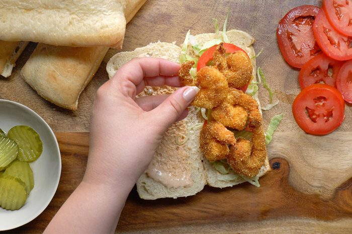 overhead shot; white background; Shrimp Po'Boys served on rectangular tray
