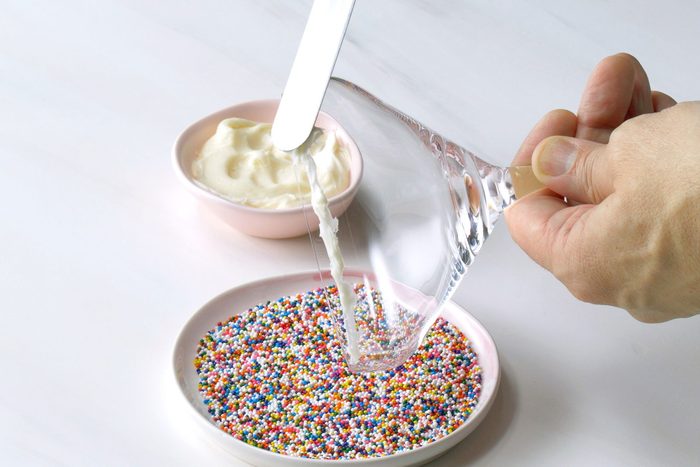 Rim the martini glass with the vanilla frosting