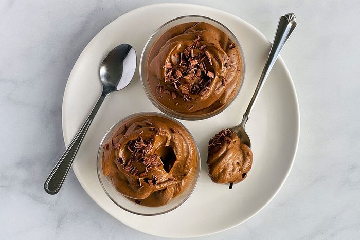 Overhead shot of Avocado Chocolate Mousse on white marble