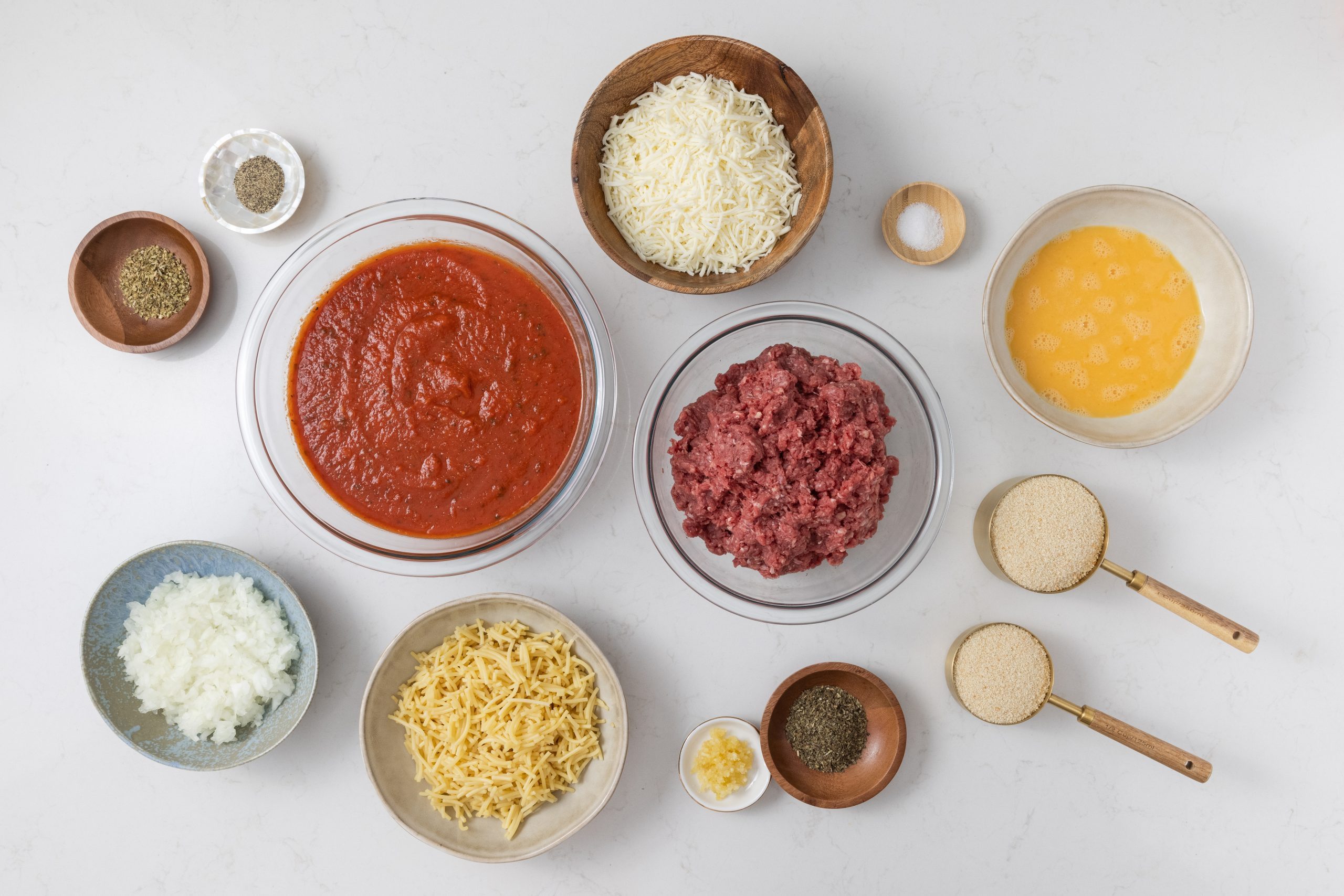 Ingredients for baked spaghetti and meatballs on kitchen counter.