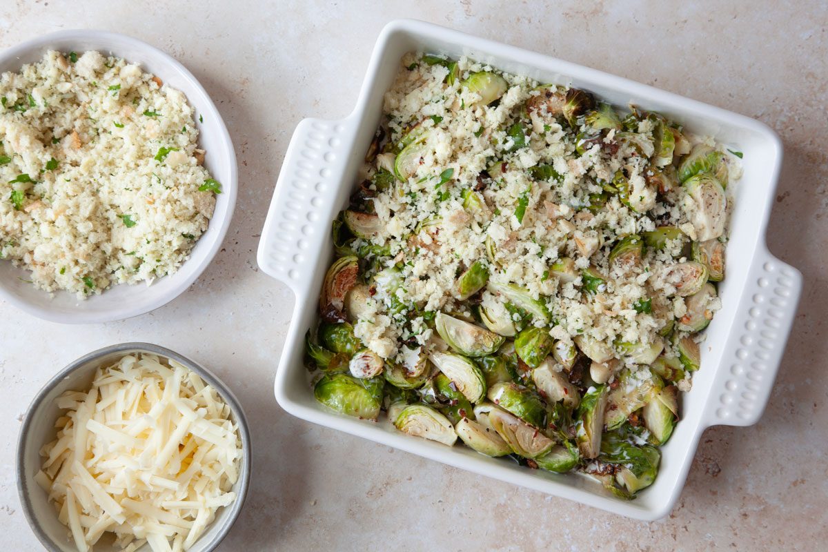 Step 4 of Taste of Home Brussels Sprouts au Gratin is to top the casserole with the bread crumbs and the shredded cheese