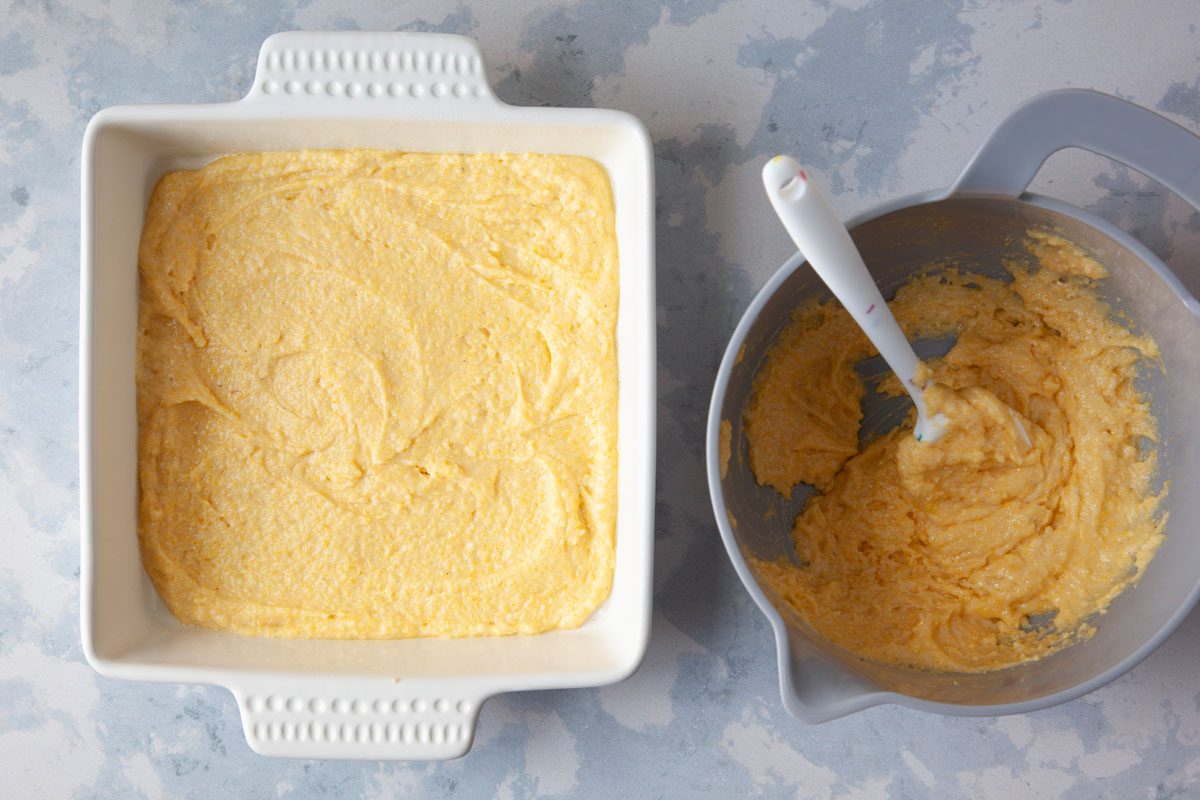 Step 1 of Taste of Home Chili Cheese Dog Casserole is preparing the cornbread batter and spreading half into the pan
