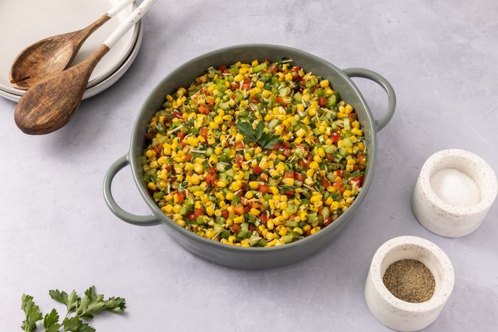 Salad ready served in round ceramic dish.