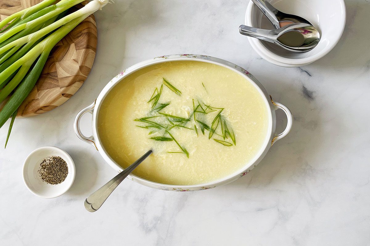 Overhead shot of Taste of Home's Egg Drop Soup recipe in a serving bowl on a white marble background