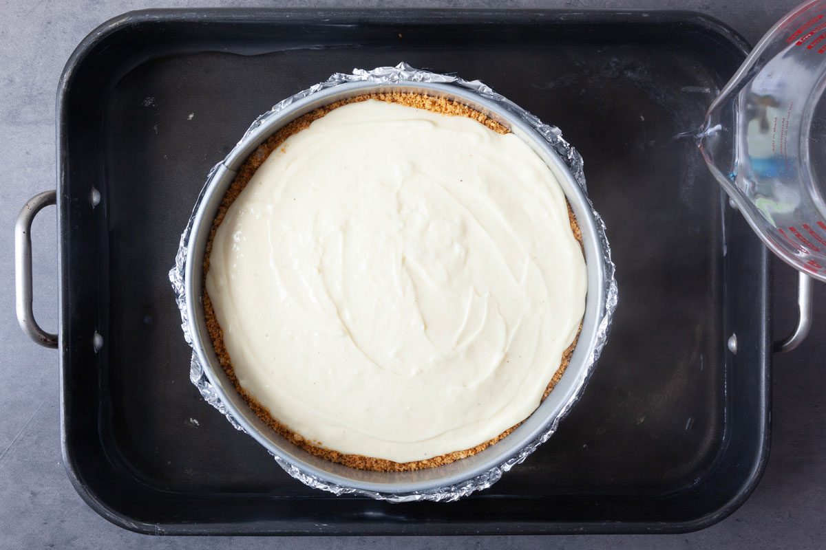 Step 4 one Taste of Home Eggnog Cheesecake is to place the pan into a larger roasting pan before adding hot water and baking