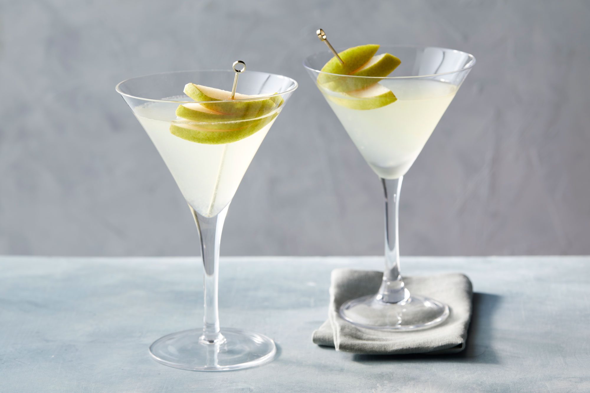 Two glasses of Pear martini garnished with pear slices