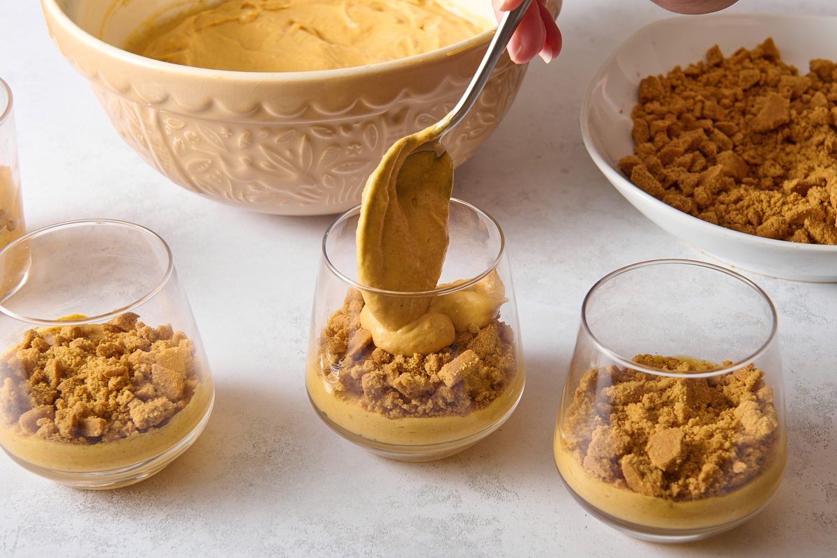 Layering the pumpkin mousse into individual serving glasses