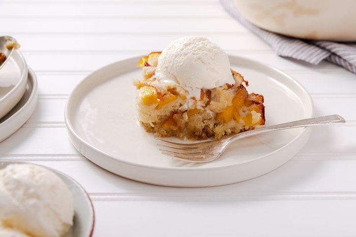 Nectarine Cobbler on a plate served with ice cream on top