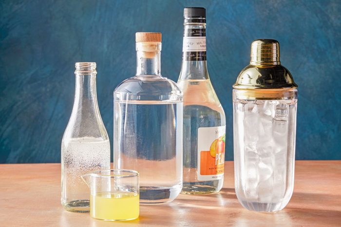 Table view shot of all ingredients for white tea shots; light orange background;