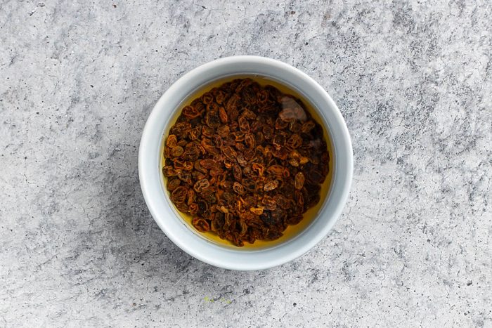 Taste of Home Applesauce Cake photo of the raisins soaking in water.