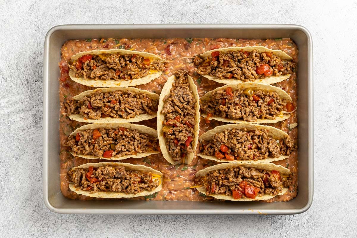 Taste of Home Baked Tacos recipe photo of filling the taco shells with the beef mixture.