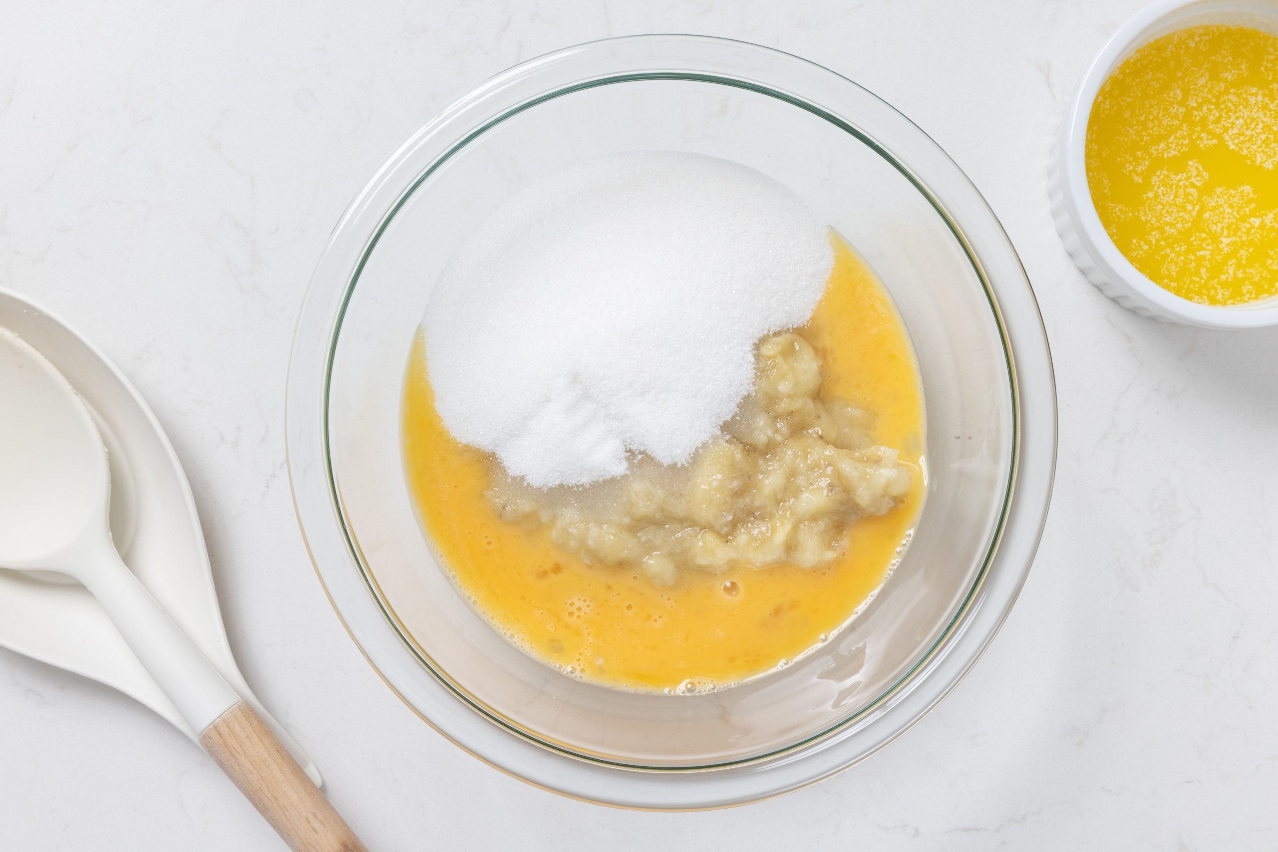 Wet ingredients being mixed in mixing bowl.