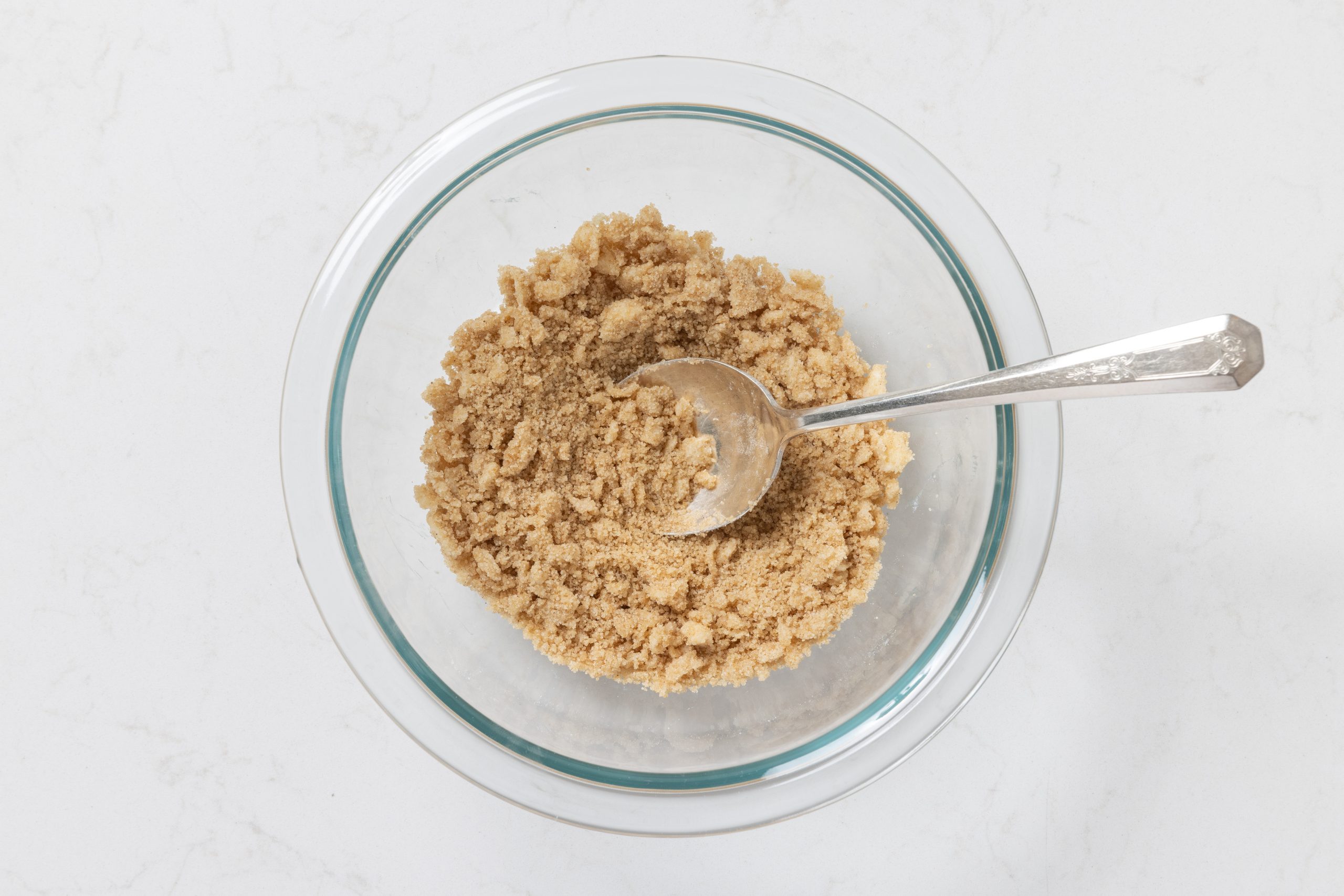 Ingredients for crumb topping being mixed in mixing bowl.