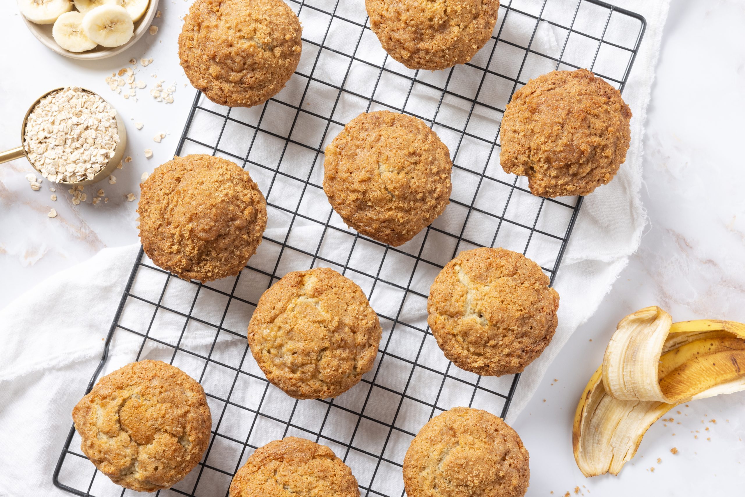 Banana crumb muffins baked and displayed on wire rack.