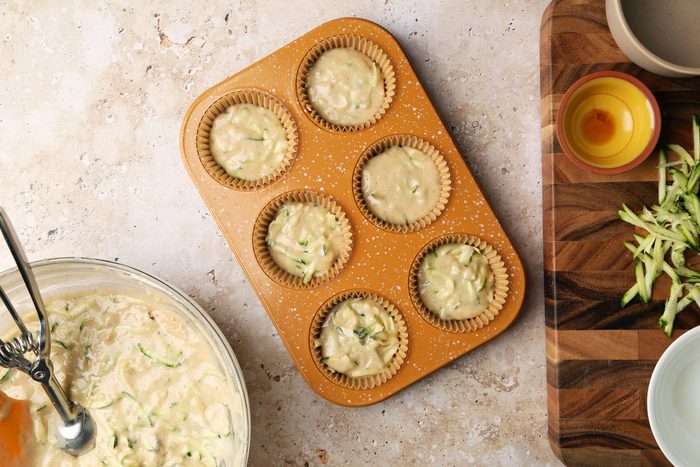Process shot of Taste of Home's Banana Zucchini Muffins. Batter in muffin tins.