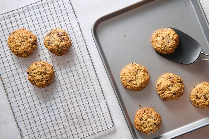 Baked breakfast cookies being transferred to a cooling rack