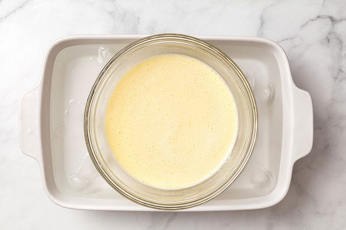 Ice cream mixture chilling in ice water in a pan for Butter Brickle Ice Cream for Taste of Home