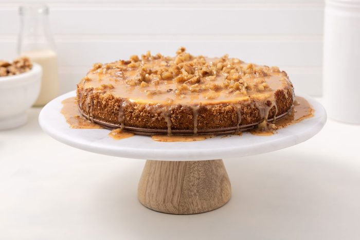 Cheesecake Ready With Caramel Sauce On Top On Cake Stand.