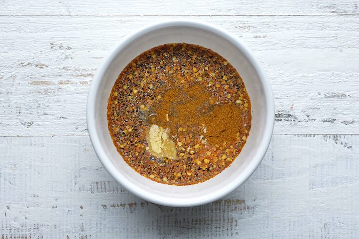 overhead shot; white textured background; In a small bowl, whisk vinegar, Worcestershire sauce, sugar and seasonings;