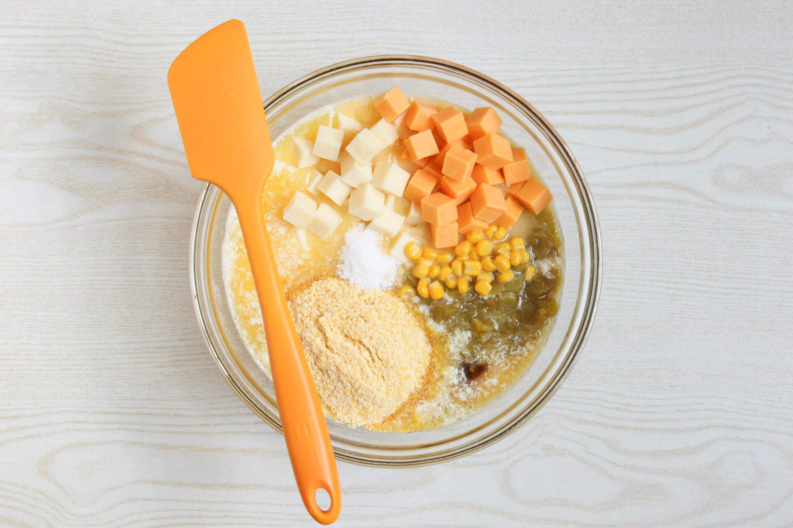 Cheesy Corn Casserole ingredients in a mixing bowl