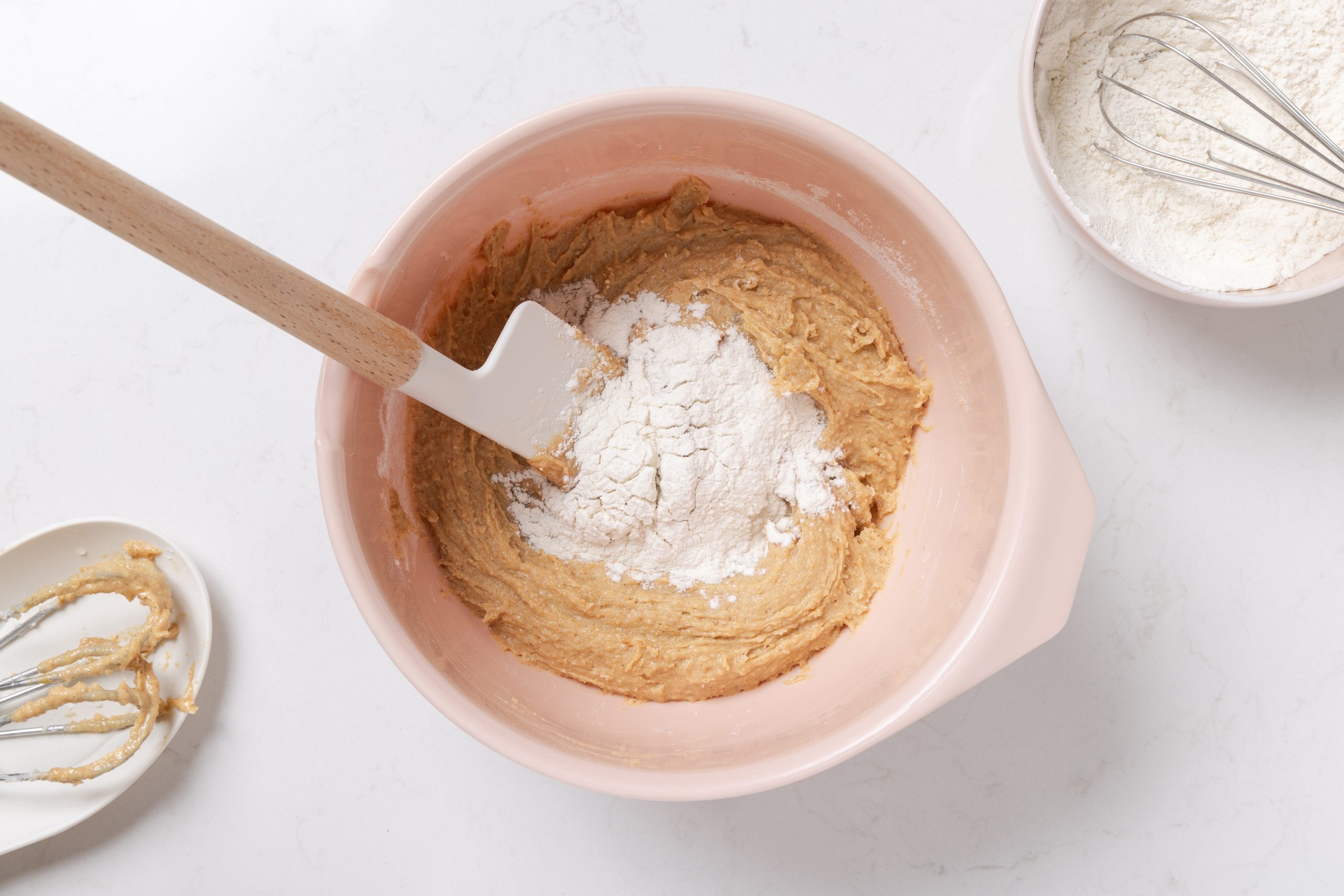Cookie dough being mixed in mixing bowl.