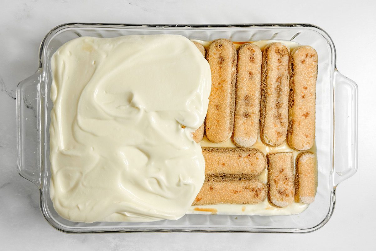 Taste of Home Easy Tiramisu in a glass baking dish on a marble surface