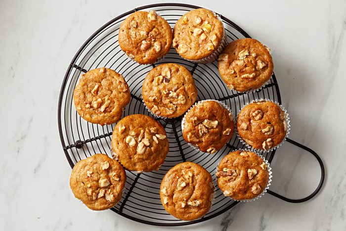 Baked muffins cooling on a wire rack.