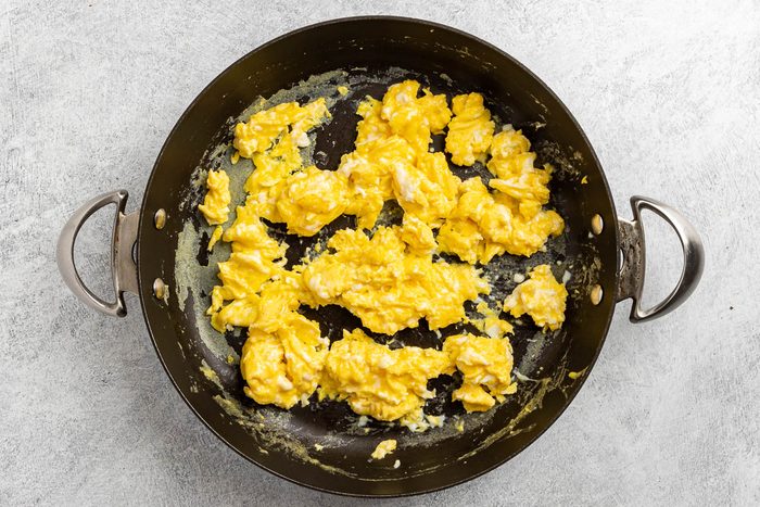 Taste of Home Ham Egg and Cheese Sandwich recipe photo of the cooked eggs in a skillet.