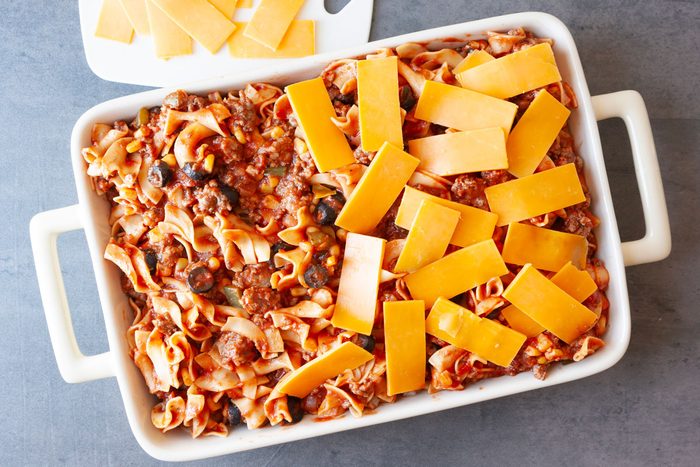 Step 3 of Taste of Home Italian Casserole is to pour the mixture into two greased 13x9-inch baking dishes. Top each with cheese, then cover the casserole and bake it for 25 to 30 minutes or until heated through.