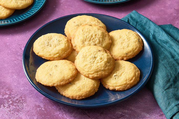 A pile of lavender cookies on a plate