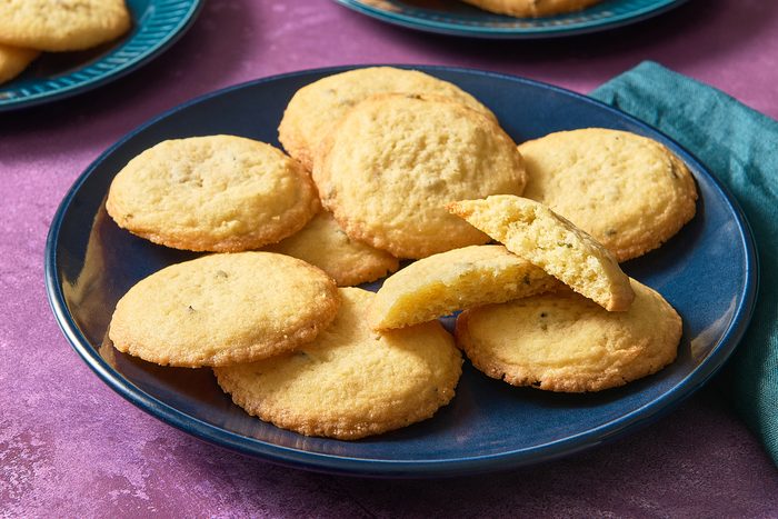 Closeup shot of a pile of lavender cookies with one broken open to reveal the interior