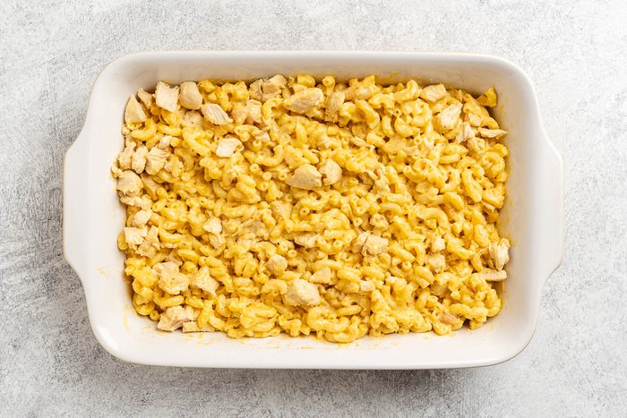Taste of Home Macaroni and Cheese with Chicken recipe photo of the macaroni, cheese sauce and chicken mixed together and spread into a baking dish.