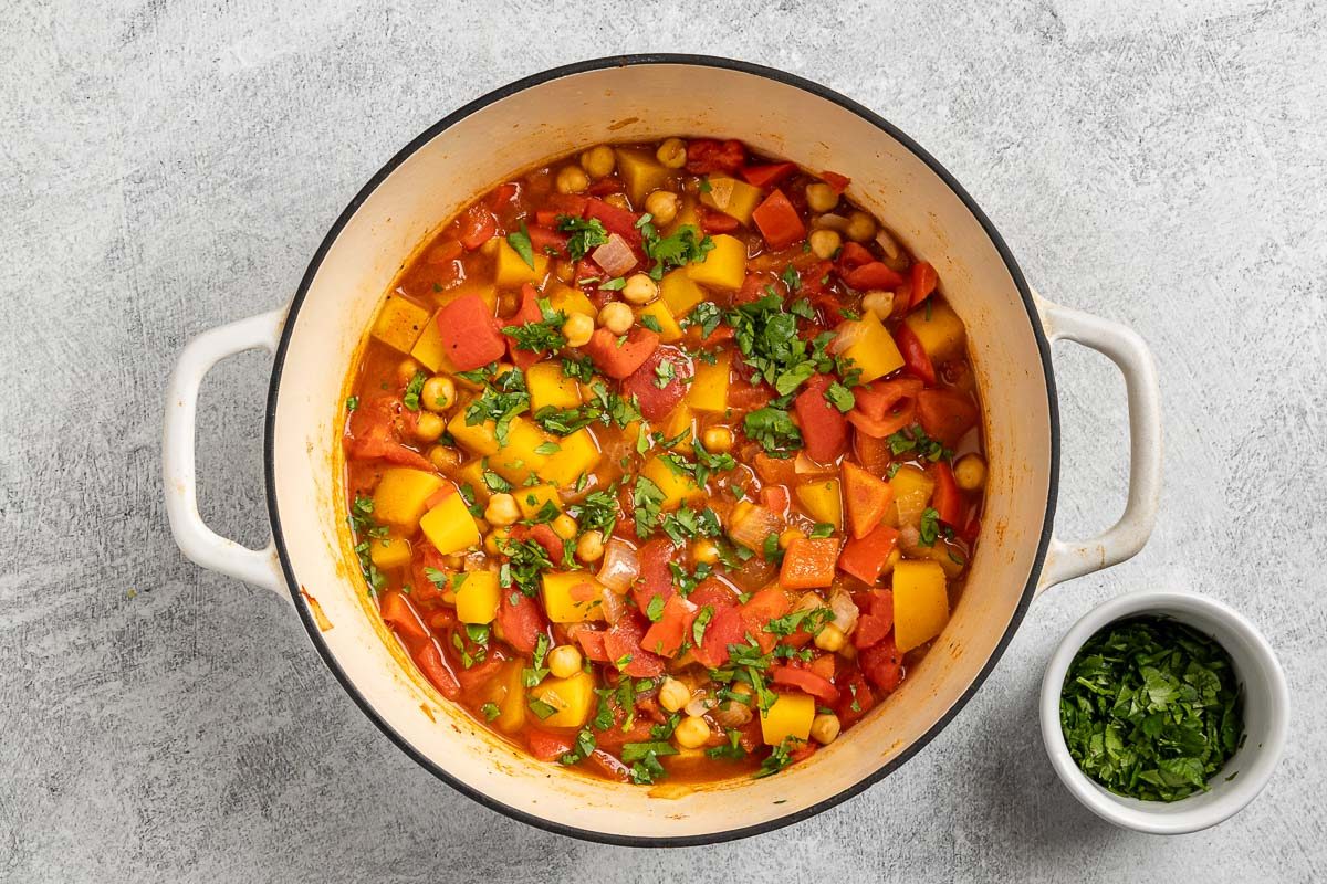 Taste of Home Moroccan Chickpea Stew recipe photo of chickpeas added to the stew, cooked and finished with chopped cilantro.