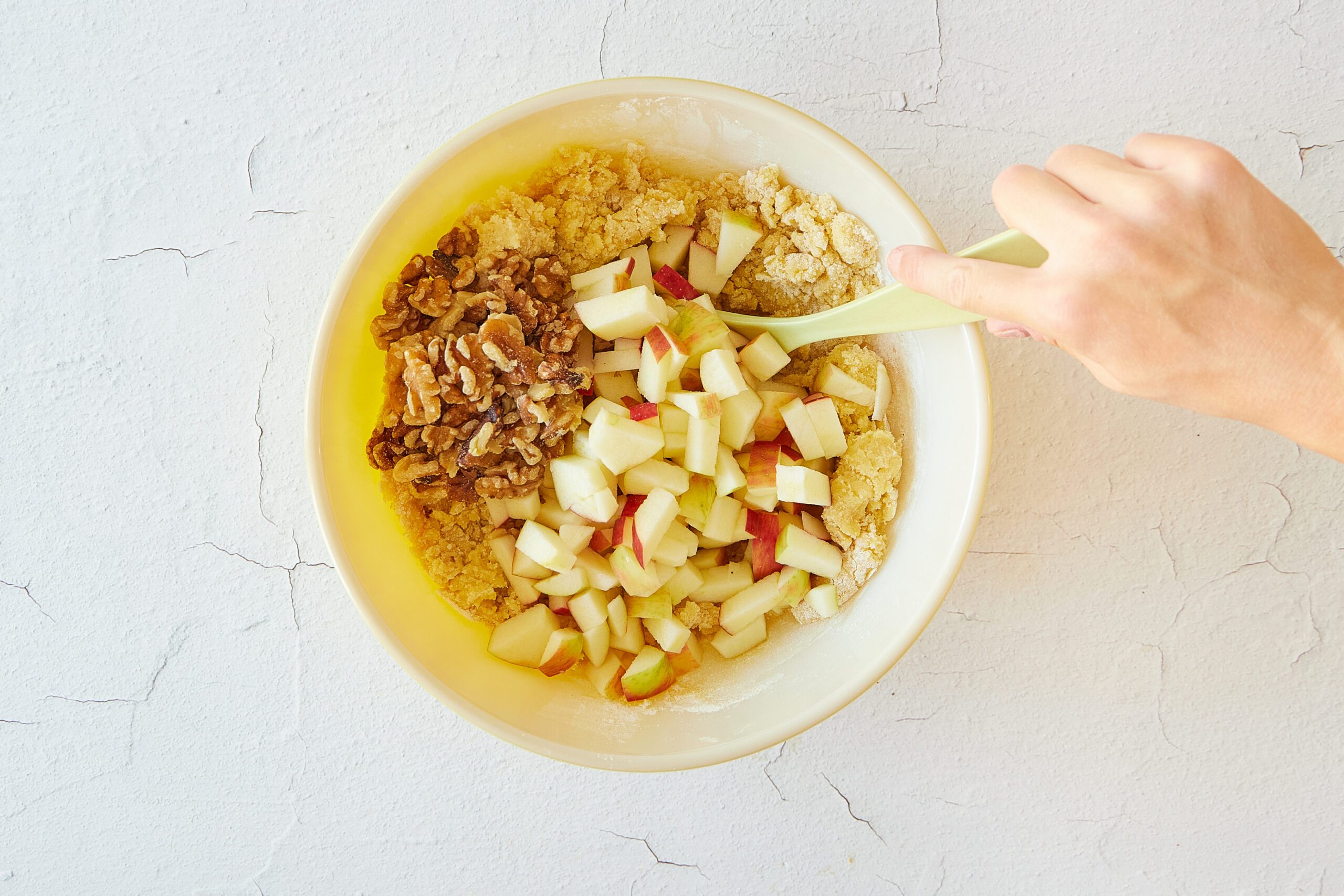 Mix the apple walnut cake batter.